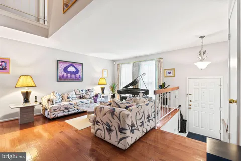 a bedroom with furniture and a wooden floor