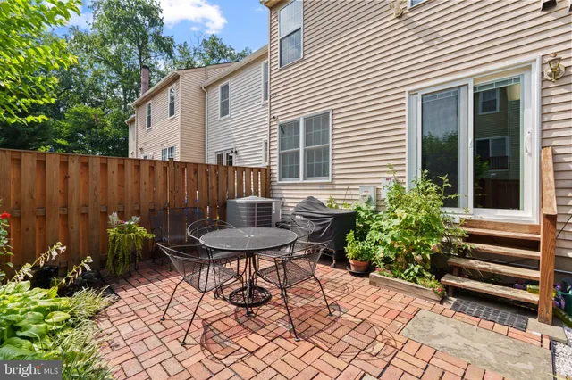 a view of a chair and table in backyard
