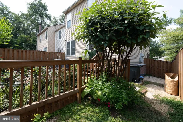 a view of a wooden fence and trees
