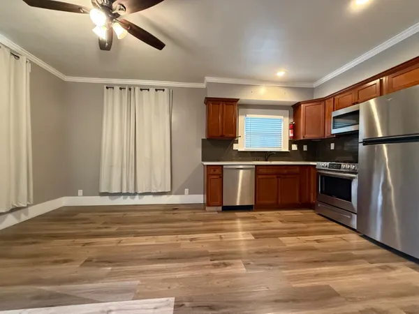 a kitchen with stainless steel appliances granite countertop a refrigerator and a sink