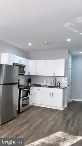 a kitchen with stainless steel appliances a refrigerator sink and stove