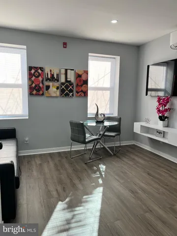 a workspace with wooden floor and a window