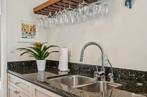 a kitchen with a stove and a white cabinets