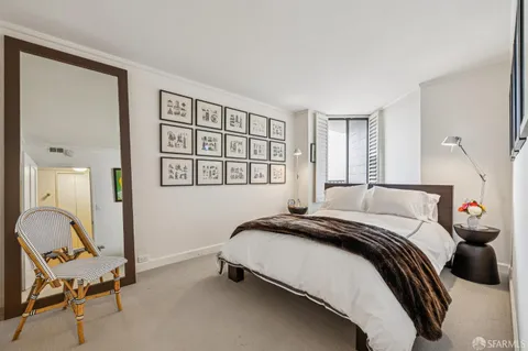 a front view of multi story residential apartment building with yard and traffic signal