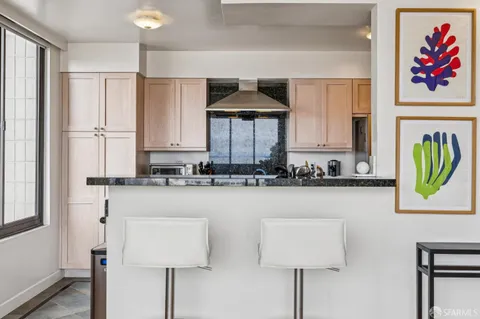 a kitchen with stainless steel appliances a sink a stove and a refrigerator
