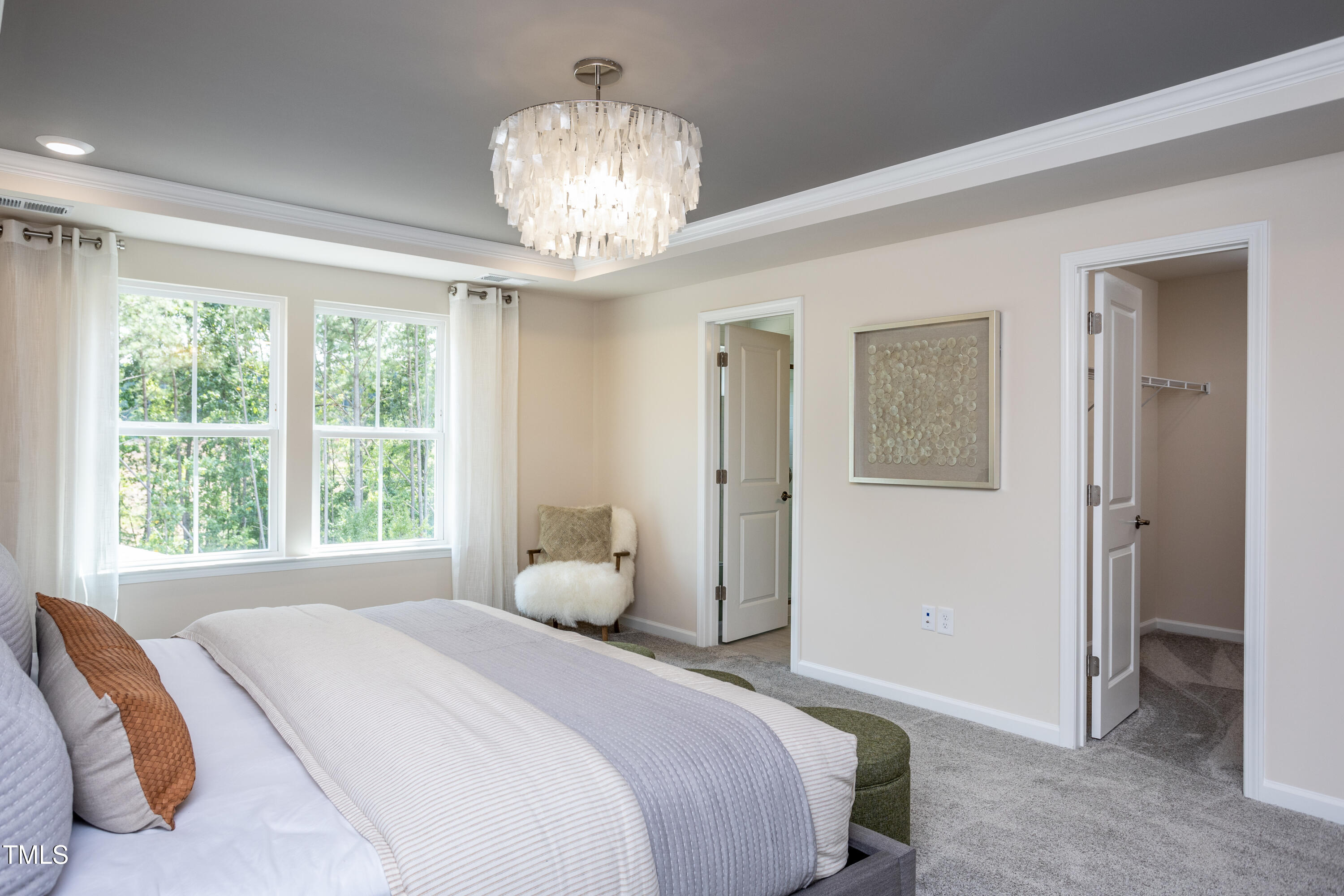 773 Denburn Place Raleigh, NC 27603 - Photo 11 of 27 a bedroom with a large bed and a chandelier