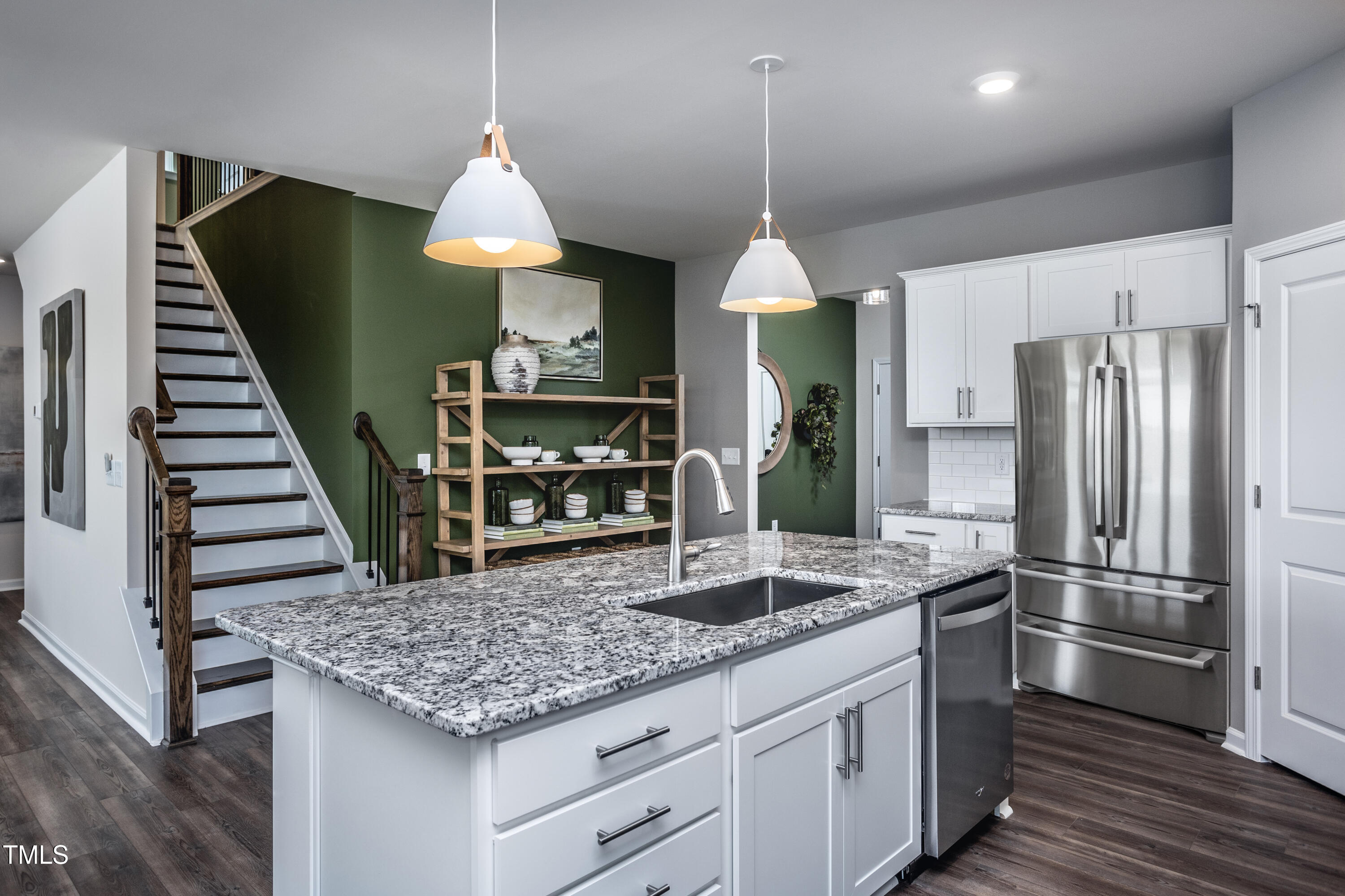 773 Denburn Place Raleigh, NC 27603 - Photo 5 of 27 a kitchen with stainless steel appliances granite countertop a refrigerator a stove and a sink