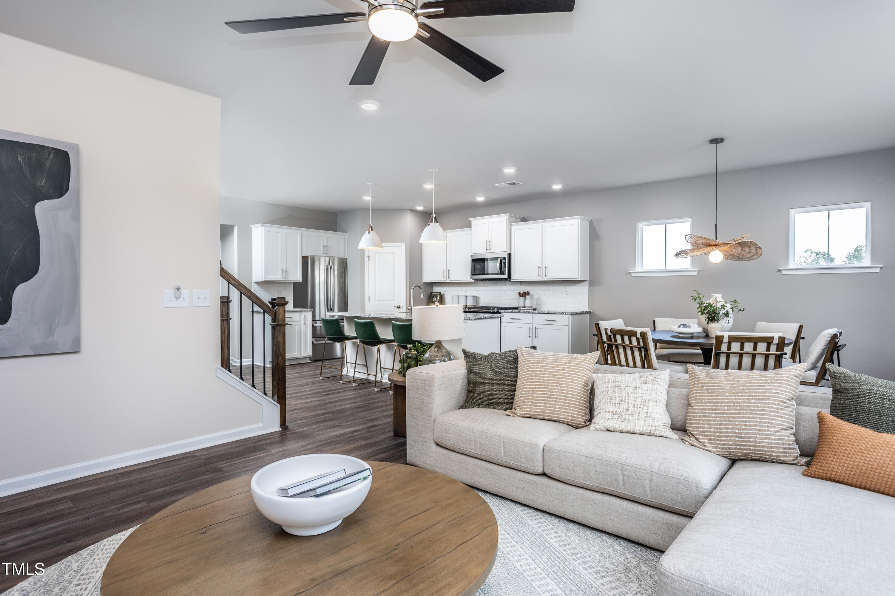 773 Denburn Place Raleigh, NC 27603 - Photo 8 of 27 a living room with furniture kitchen view and a wooden floor
