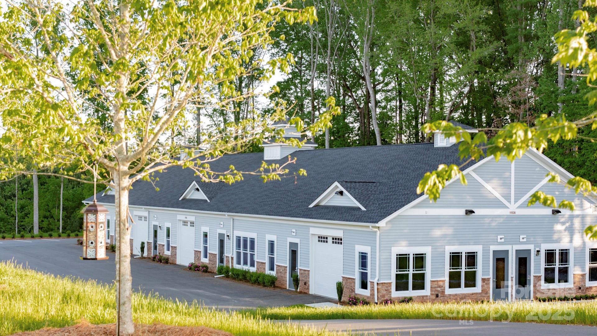 12821 Mayes Road Huntersville, NC 28078 - Photo 15 of 17 a view of a white house with a big yard and large trees