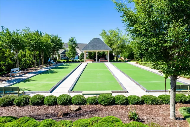 a view of a big yard with a small house