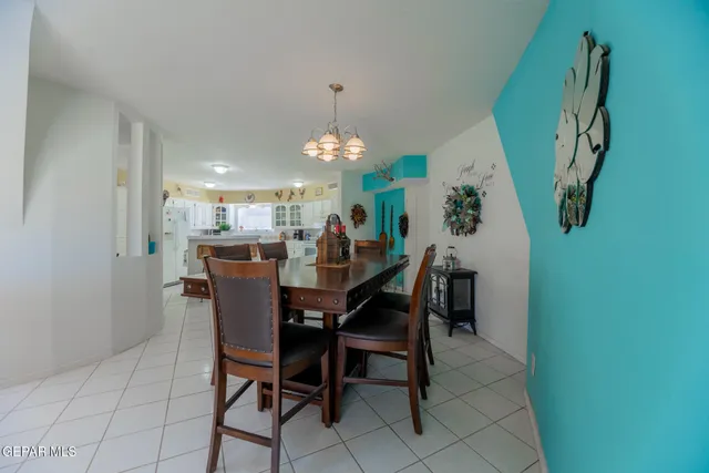 a view of a dining room with furniture and chandelier