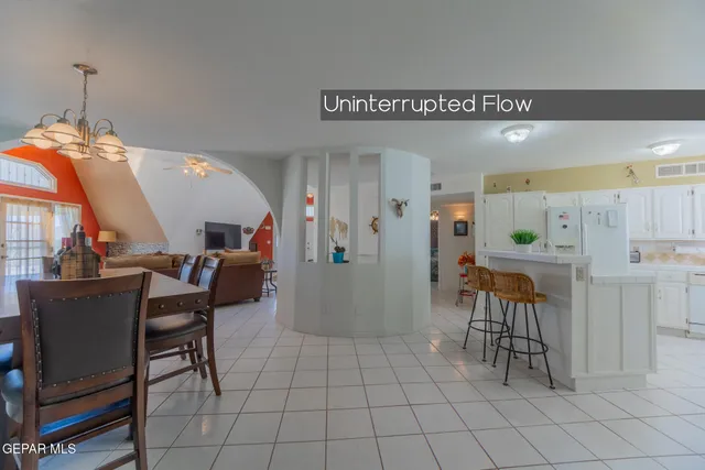 a view of a dining room with furniture and a chandelier
