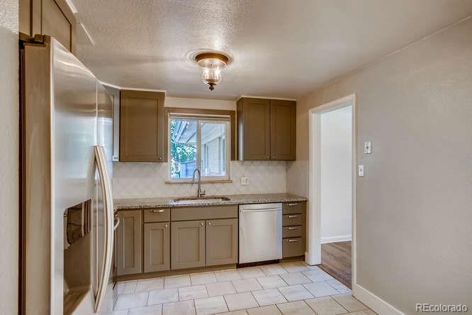 3232 West 28th Avenue Denver, CO 80211 - Photo 3 of 9 a kitchen with a sink and cabinets