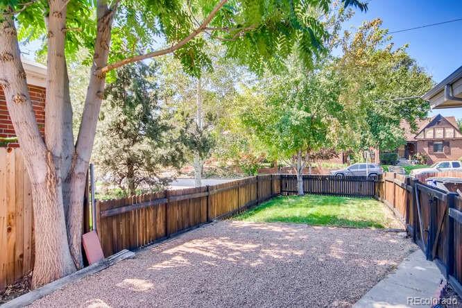 3232 West 28th Avenue Denver, CO 80211 - Photo 8 of 9 a view of a backyard with a garden and deck