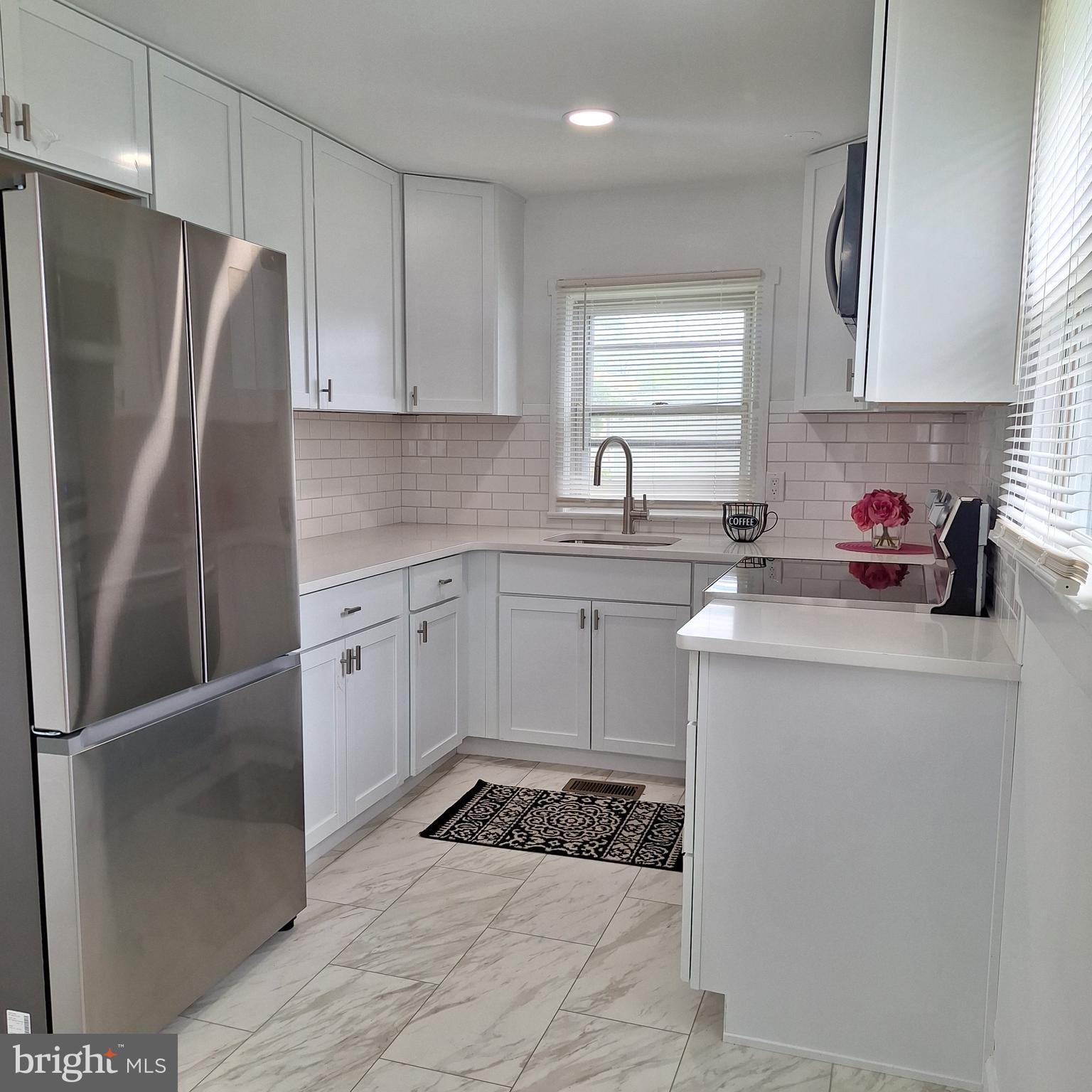 734 Pulaski Highway Bear, DE 19701 - Photo 13 of 20 a kitchen with a sink a refrigerator and cabinets