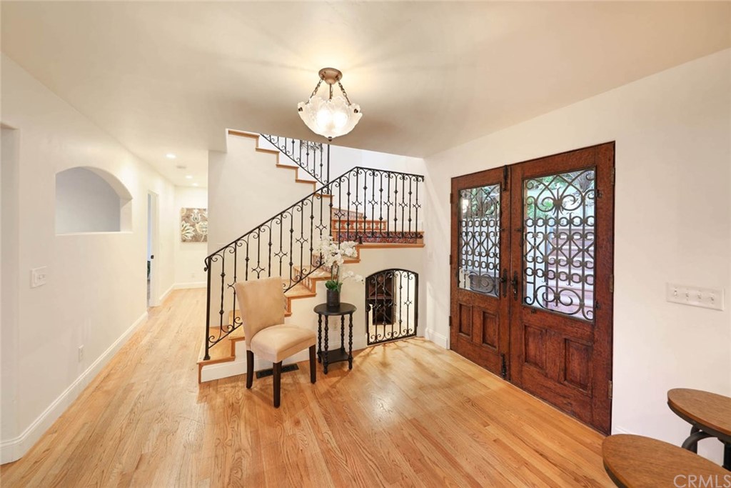 1107 Coast View Drive Laguna Beach, CA 92651 - Photo 11 of 48 a view of a livingroom with furniture a fireplace wooden floor and windows