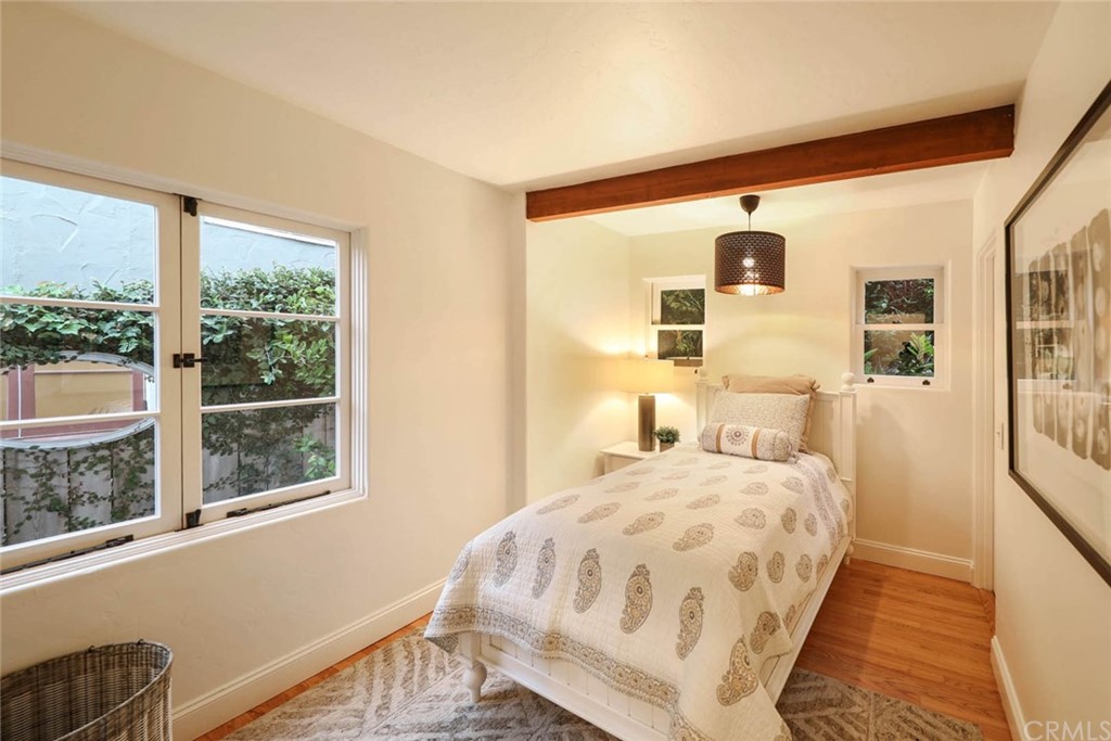 1107 Coast View Drive Laguna Beach, CA 92651 - Photo 18 of 48 a bedroom with a large bed and a window