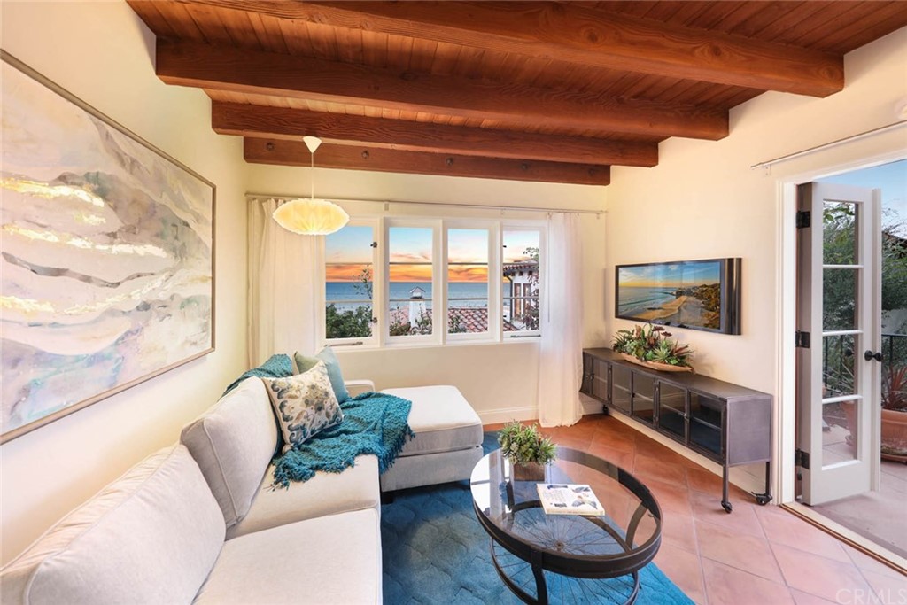 1107 Coast View Drive Laguna Beach, CA 92651 - Photo 19 of 48 a living room with furniture and a large window
