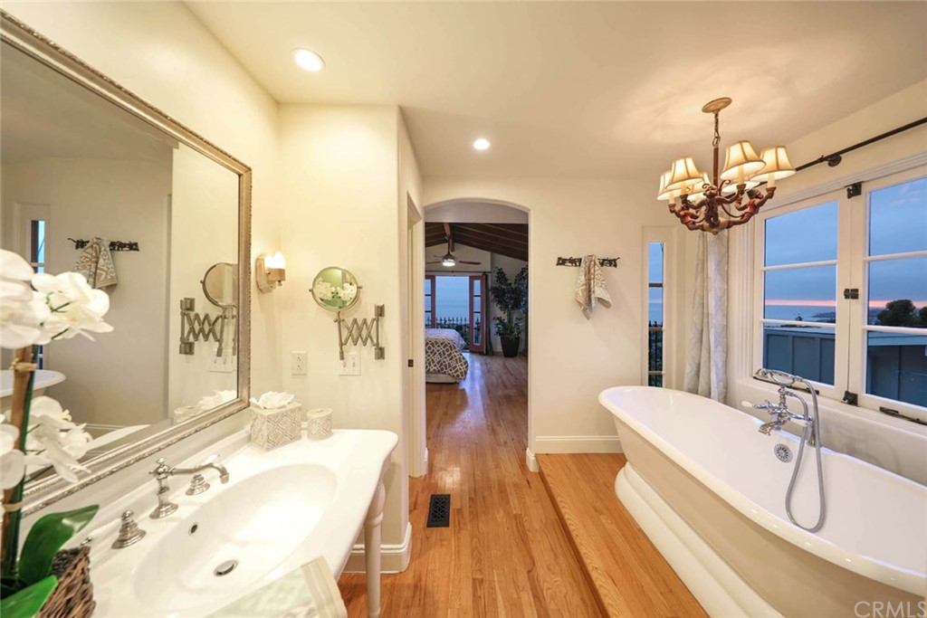 1107 Coast View Drive Laguna Beach, CA 92651 - Photo 31 of 48 a spacious bathroom with a granite countertop sink a mirror and shower