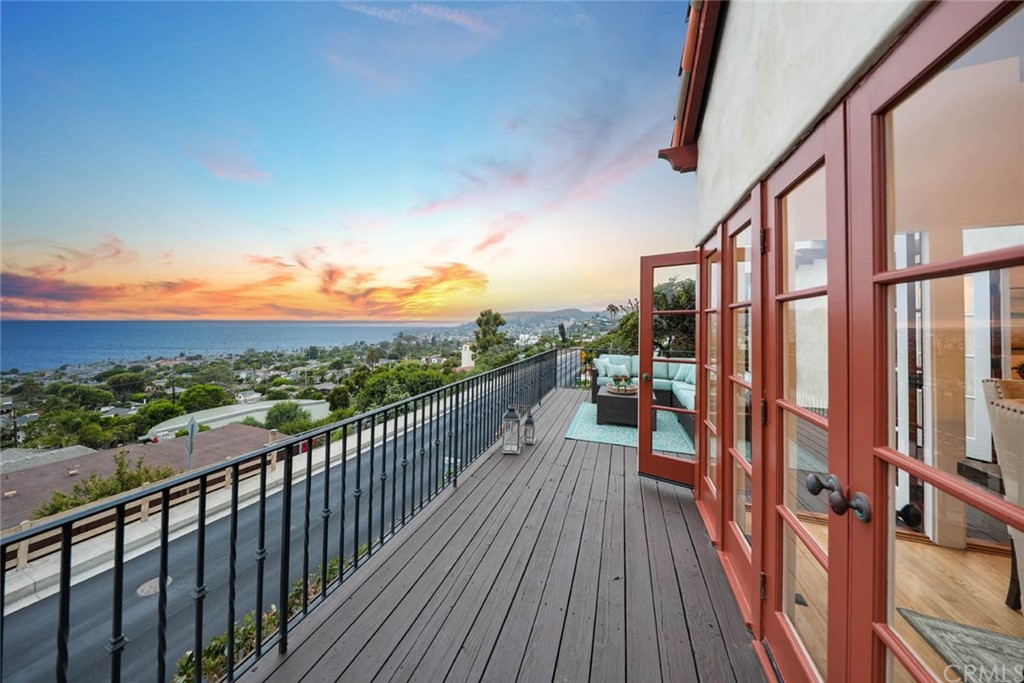 1107 Coast View Drive Laguna Beach, CA 92651 - Photo 38 of 48 a view of a balcony with wooden floor and fence