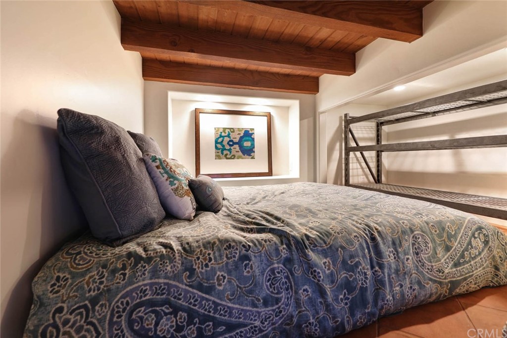 1107 Coast View Drive Laguna Beach, CA 92651 - Photo 40 of 48 a bedroom with a bed and a window