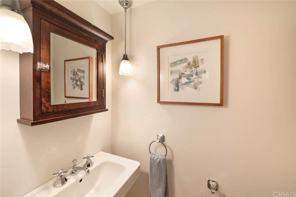 1107 Coast View Drive Laguna Beach, CA 92651 - Photo 45 of 48 a bathroom with a sink and a mirror