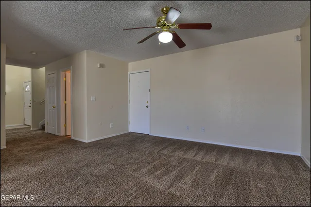 a view of staircase with white walls and white door