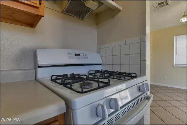 an empty room with a window and a ceiling fan