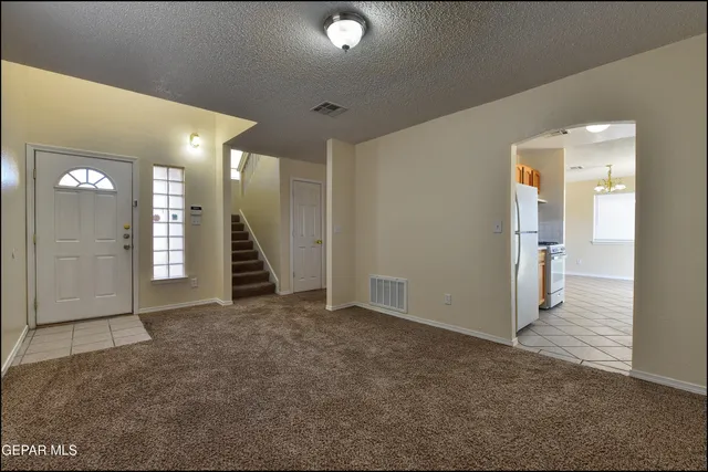 a kitchen with stainless steel appliances granite countertop a sink and a white cabinets