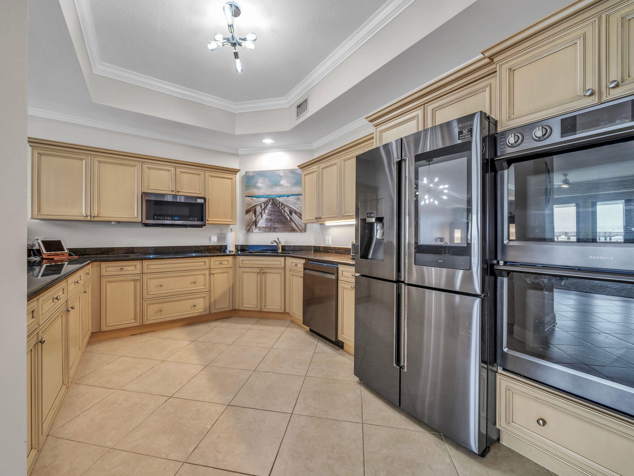 5 Calhoun Avenue, Unit 403 Destin, FL 32541 - Photo 11 of 35 a kitchen with cabinets stainless steel appliances and a window