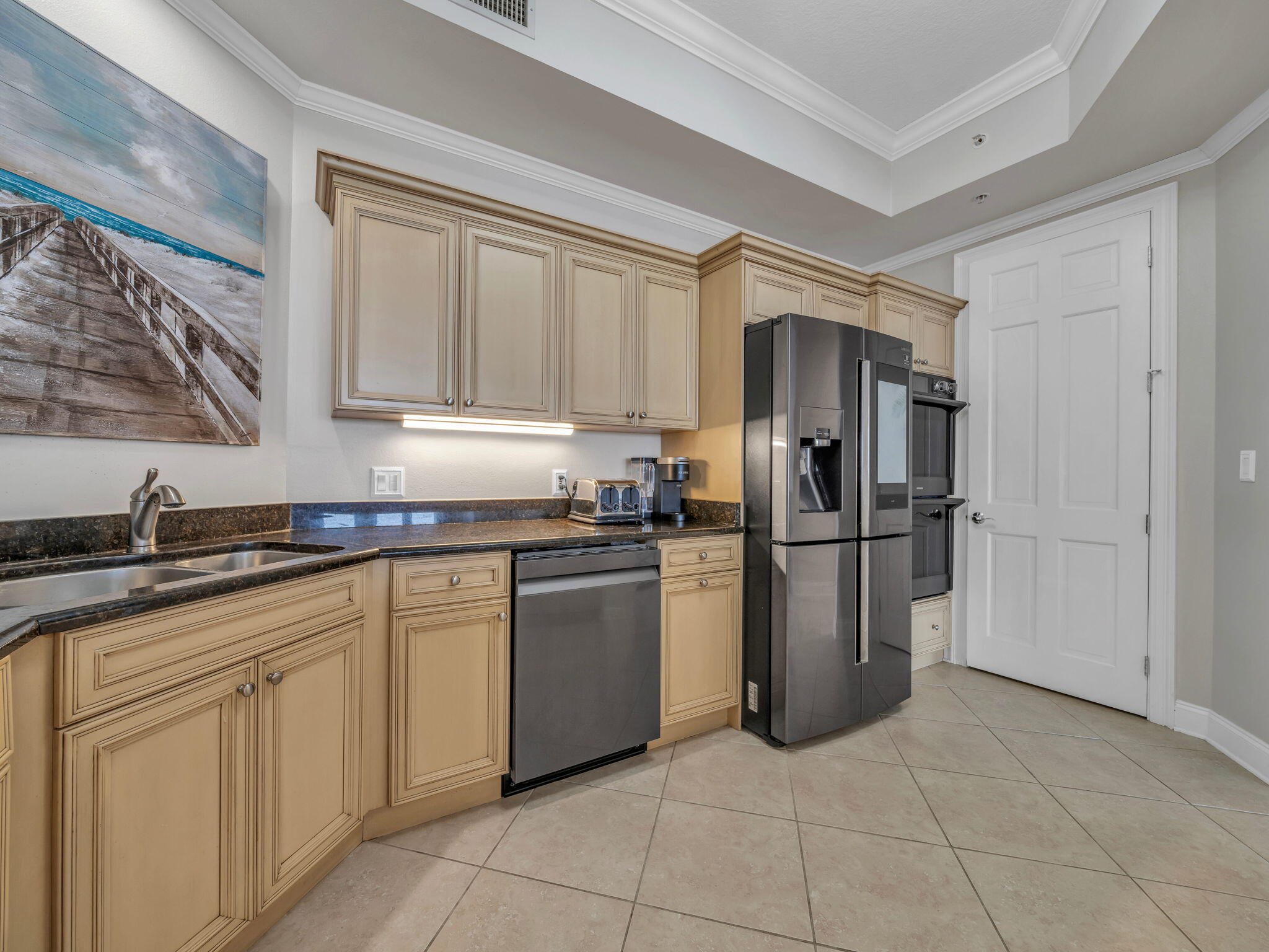 5 Calhoun Avenue, Unit 403 Destin, FL 32541 - Photo 12 of 35 a kitchen with a refrigerator sink and cabinets