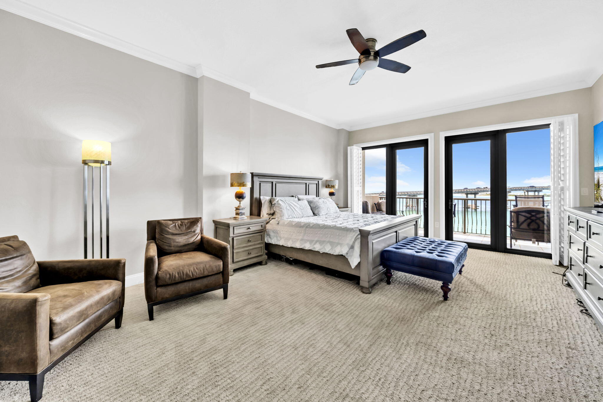 5 Calhoun Avenue, Unit 403 Destin, FL 32541 - Photo 15 of 35 a spacious bedroom with a bed a couch and a ceiling fan