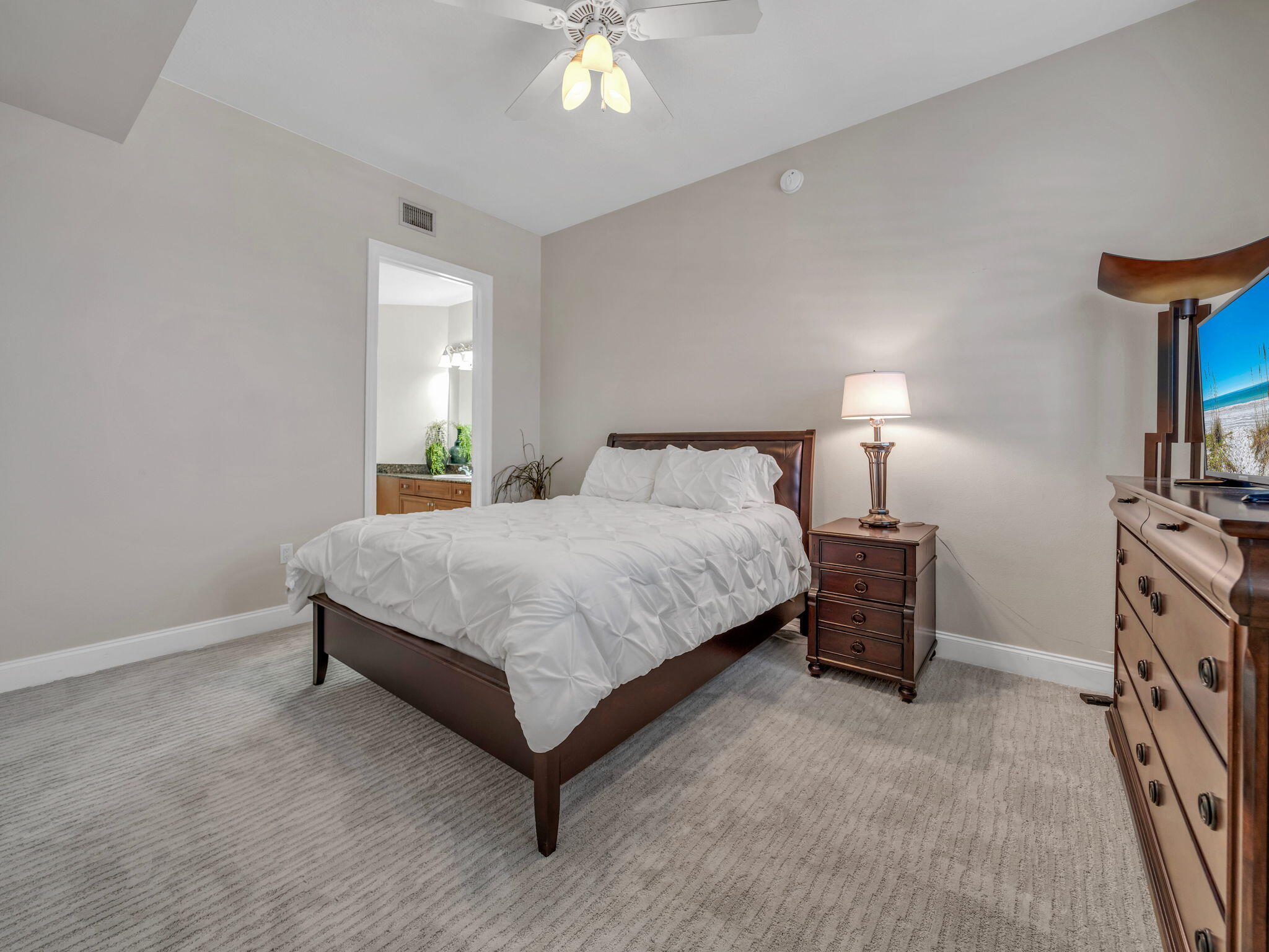5 Calhoun Avenue, Unit 403 Destin, FL 32541 - Photo 18 of 35 a bedroom with a bed and a lamp
