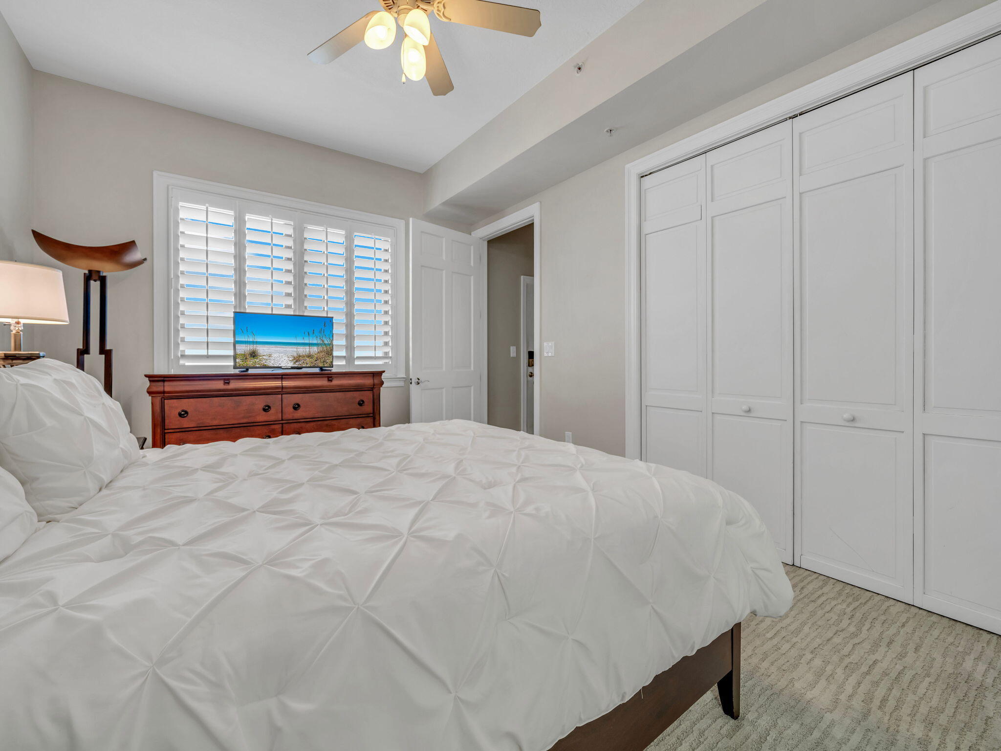 5 Calhoun Avenue, Unit 403 Destin, FL 32541 - Photo 19 of 35 a bedroom with a large bed and a window