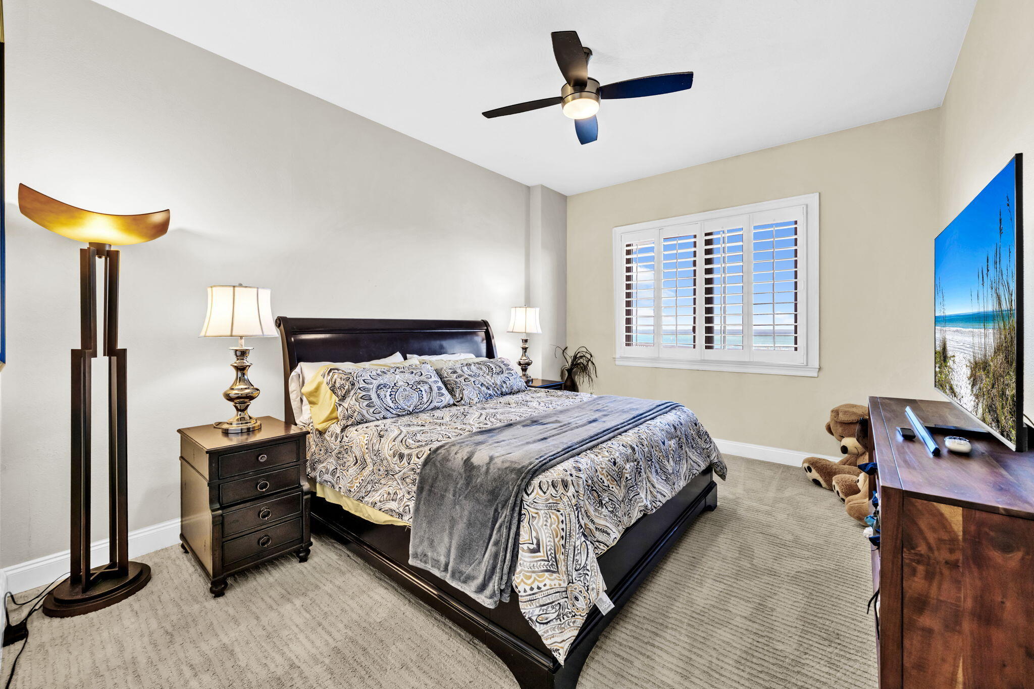 5 Calhoun Avenue, Unit 403 Destin, FL 32541 - Photo 20 of 35 a bedroom with a bed a window and a flat screen television
