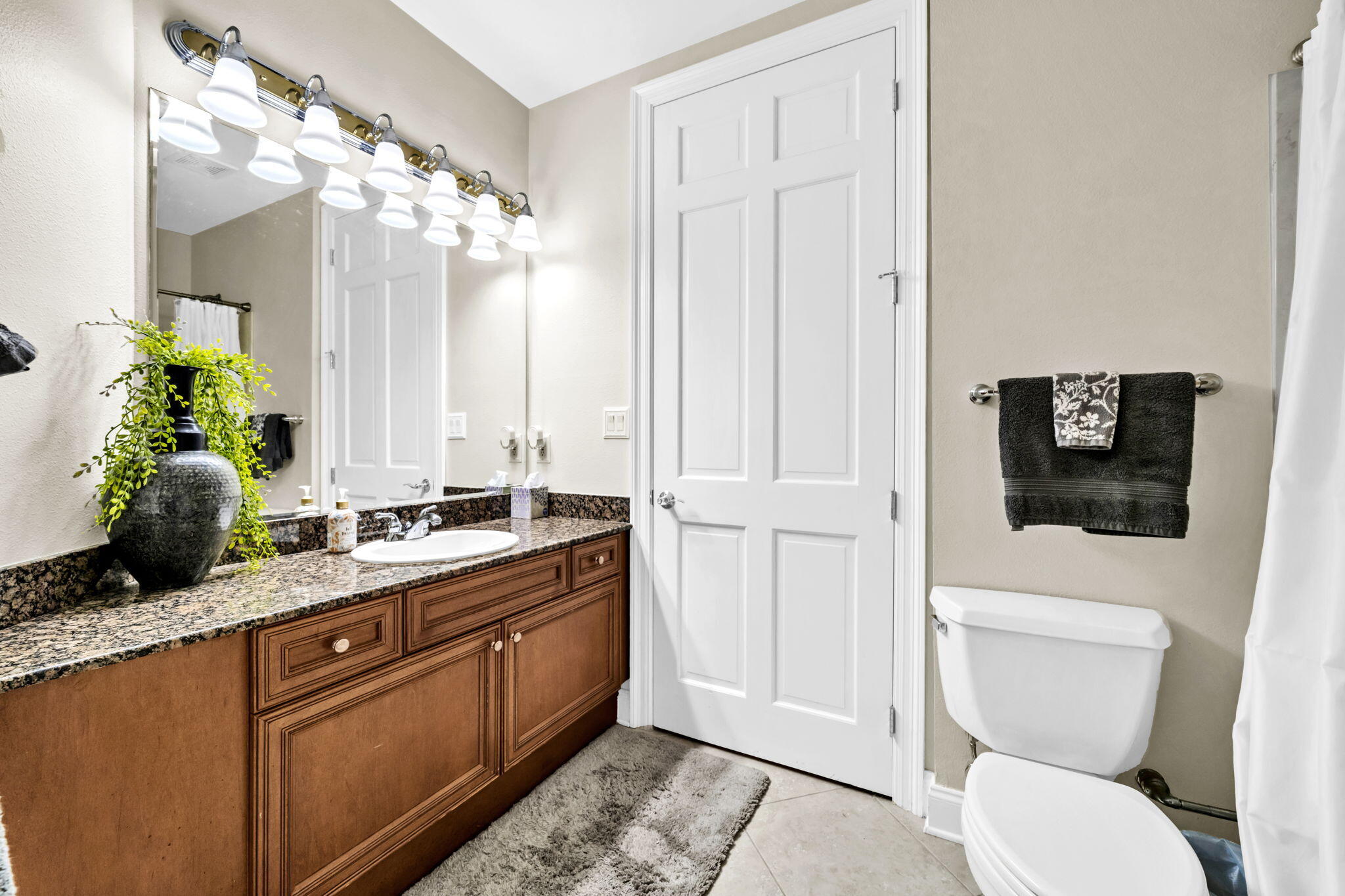 5 Calhoun Avenue, Unit 403 Destin, FL 32541 - Photo 21 of 35 a bathroom with a granite countertop sink a mirror and a toilet