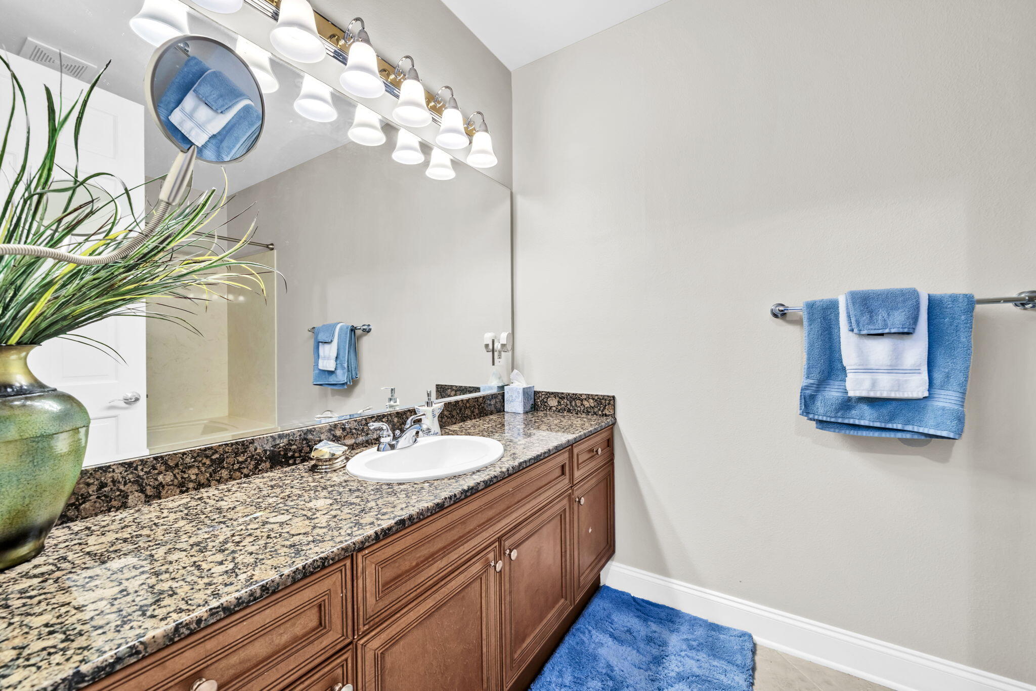 5 Calhoun Avenue, Unit 403 Destin, FL 32541 - Photo 23 of 35 a bathroom with a granite countertop sink and a mirror