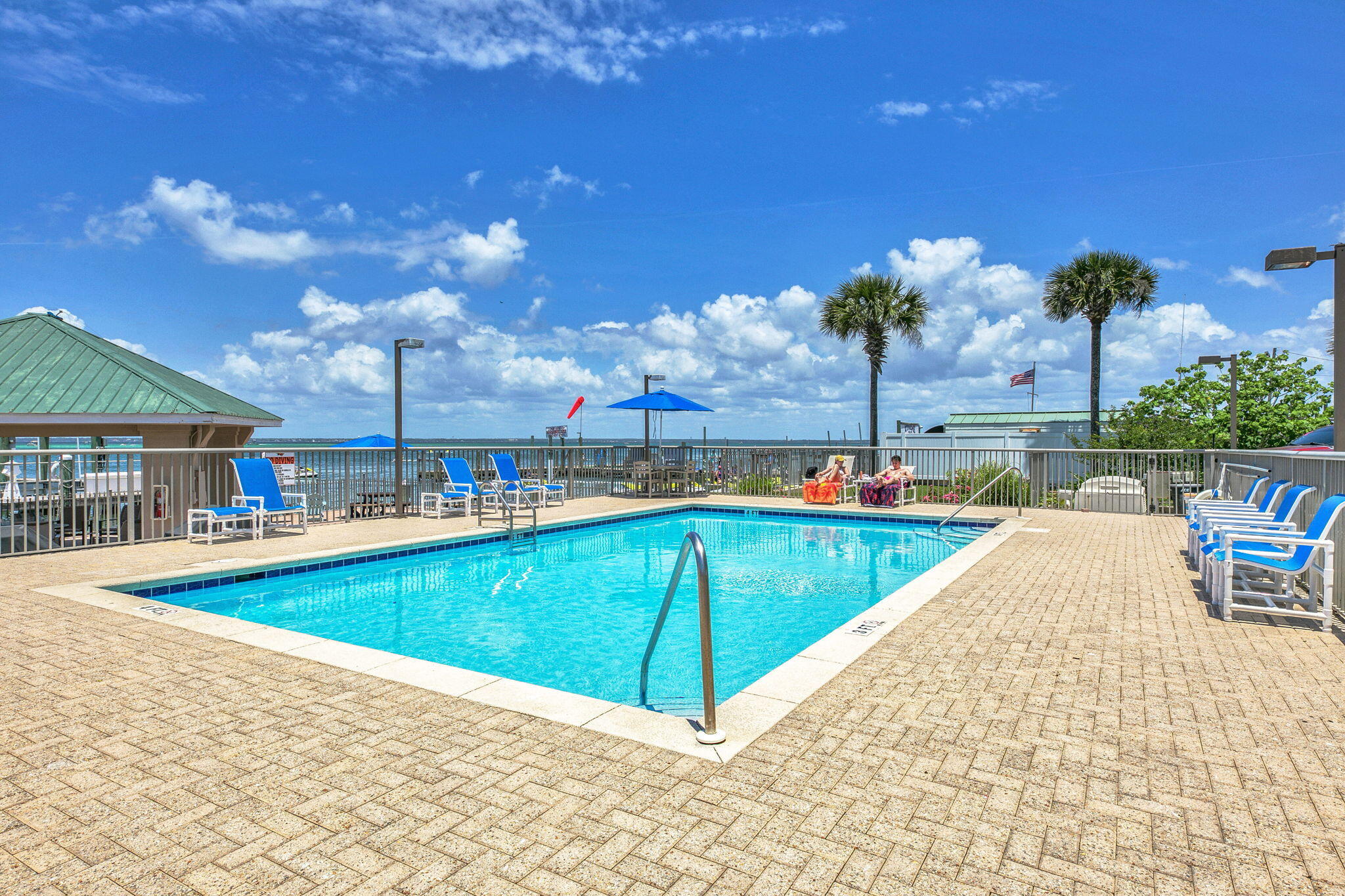 5 Calhoun Avenue, Unit 403 Destin, FL 32541 - Photo 29 of 35 a view of a swimming pool with a lounge chairs