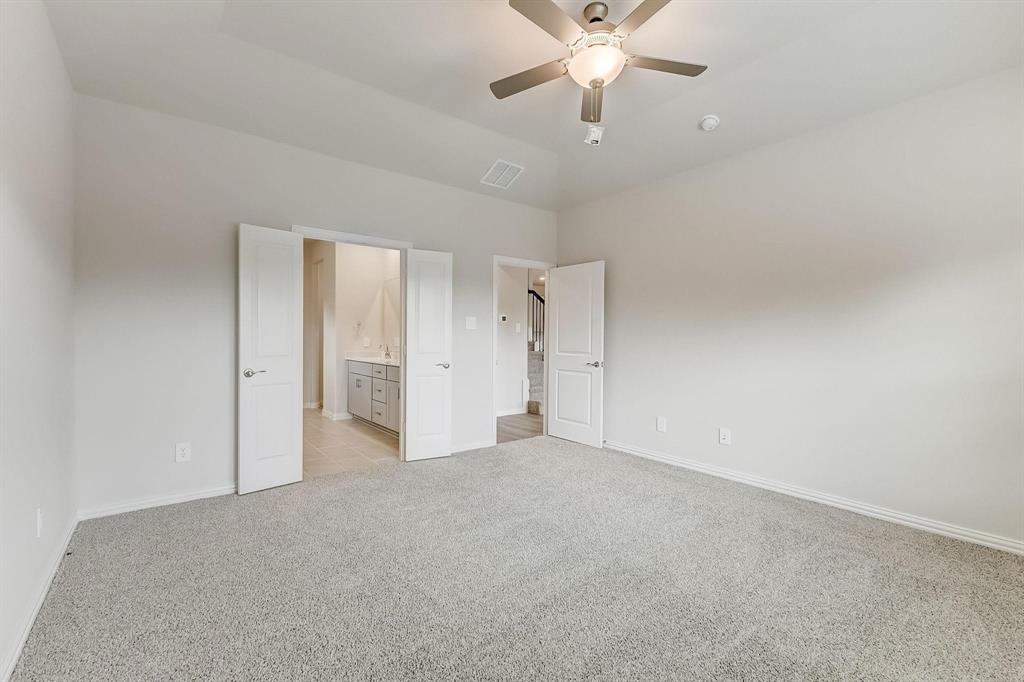 1405 Winters Way McKinney, TX 75071 - Photo 17 of 32 Unfurnished bedroom featuring ensuite bathroom, light colored carpet, and ceiling fan