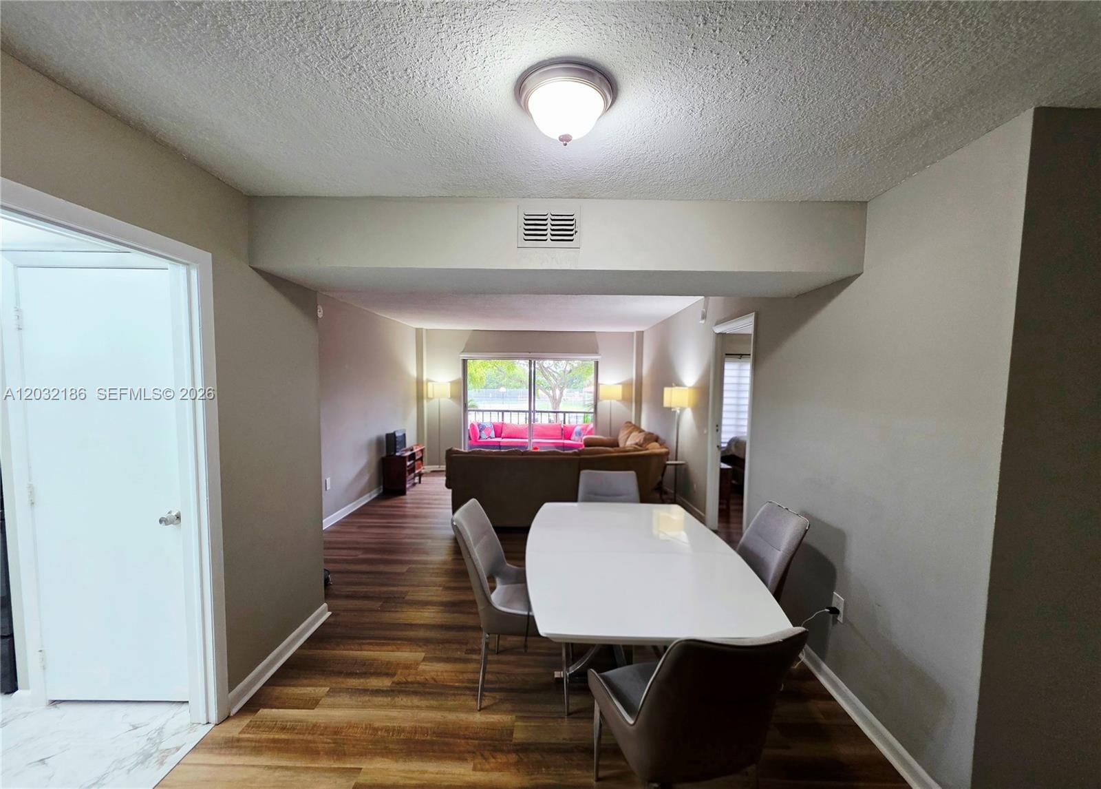 4164 Inverrary Drive, Unit 204 Lauderhill, FL 33319 - Photo 8 of 28 a view of a dining room with furniture window and wooden floor