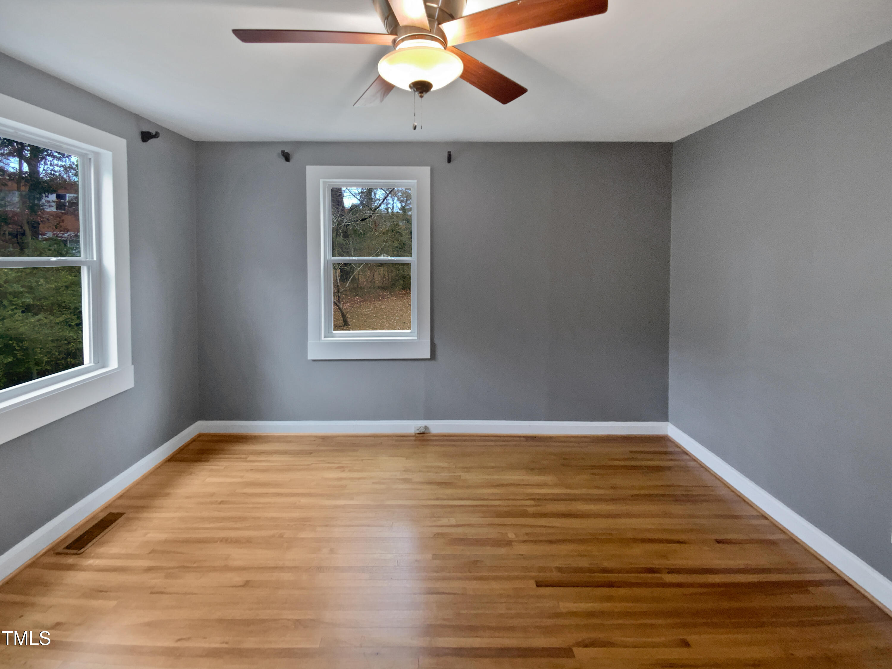 802 Powell Drive Garner, NC 27529 - Photo 11 of 17 wooden floor in an empty room with a window