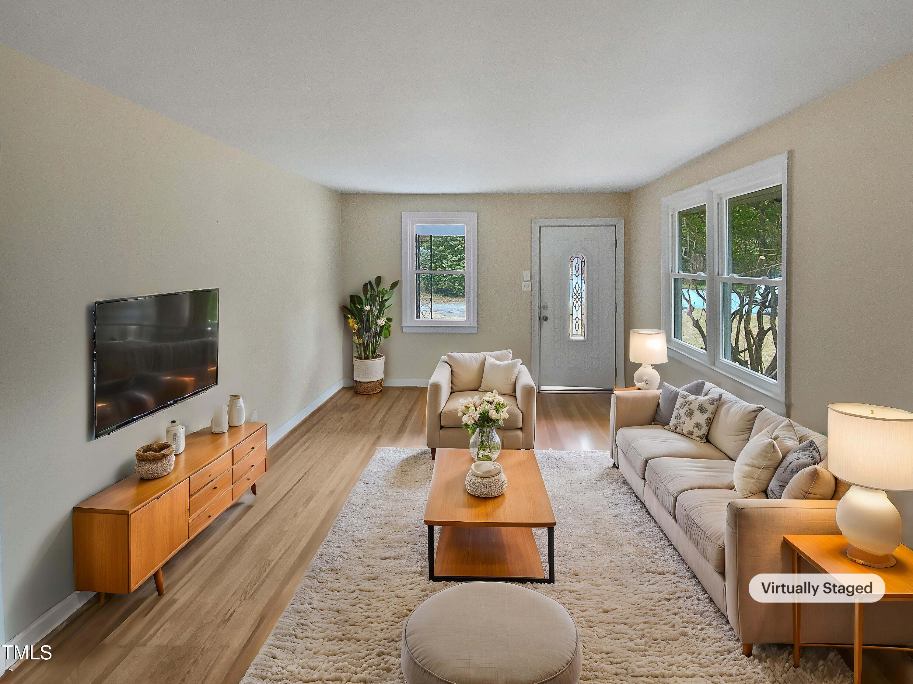 802 Powell Drive Garner, NC 27529 - Photo 2 of 17 a living room with furniture and a flat screen tv