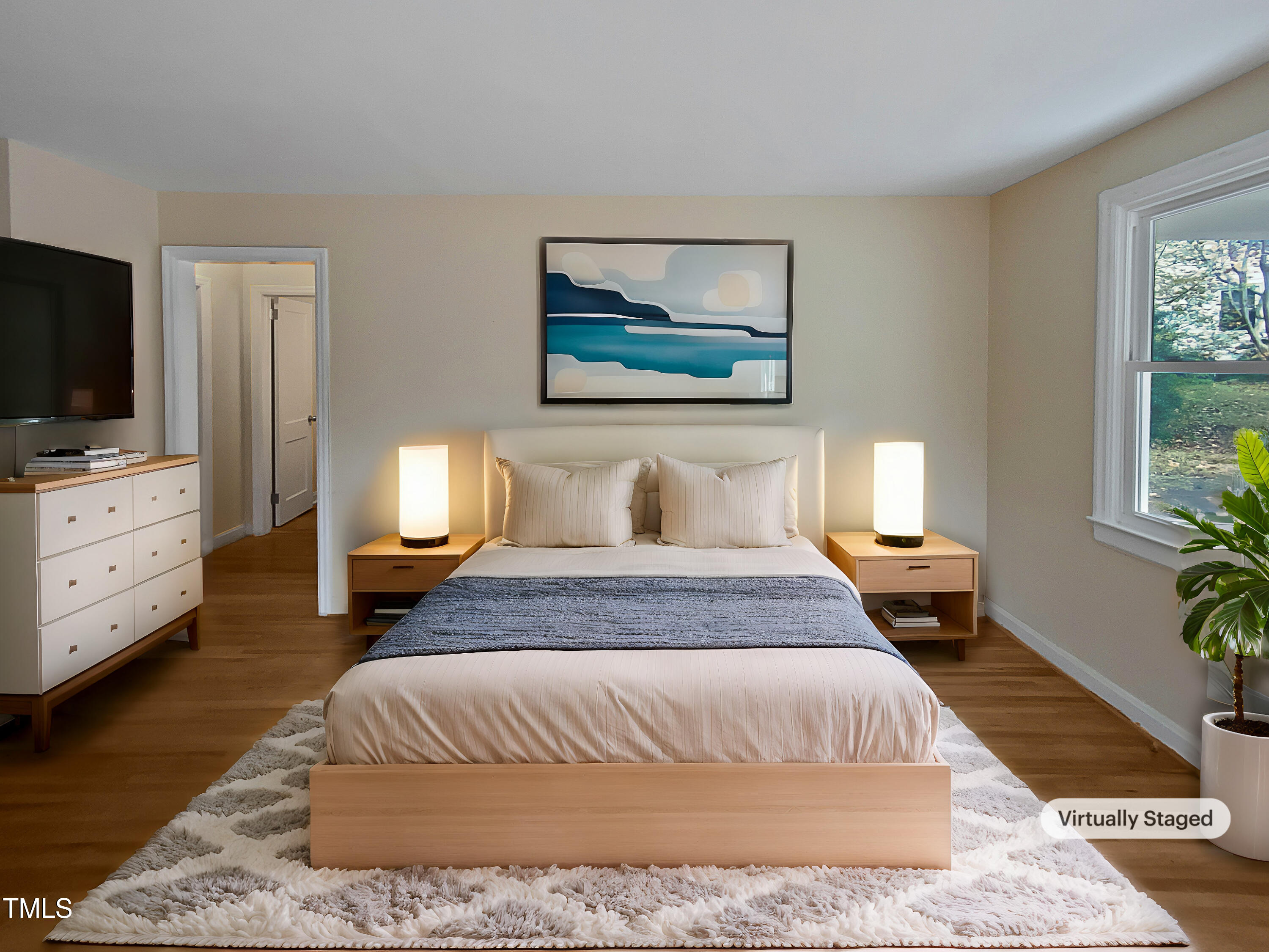 802 Powell Drive Garner, NC 27529 - Photo 4 of 17 a bedroom with a bed and wooden floor