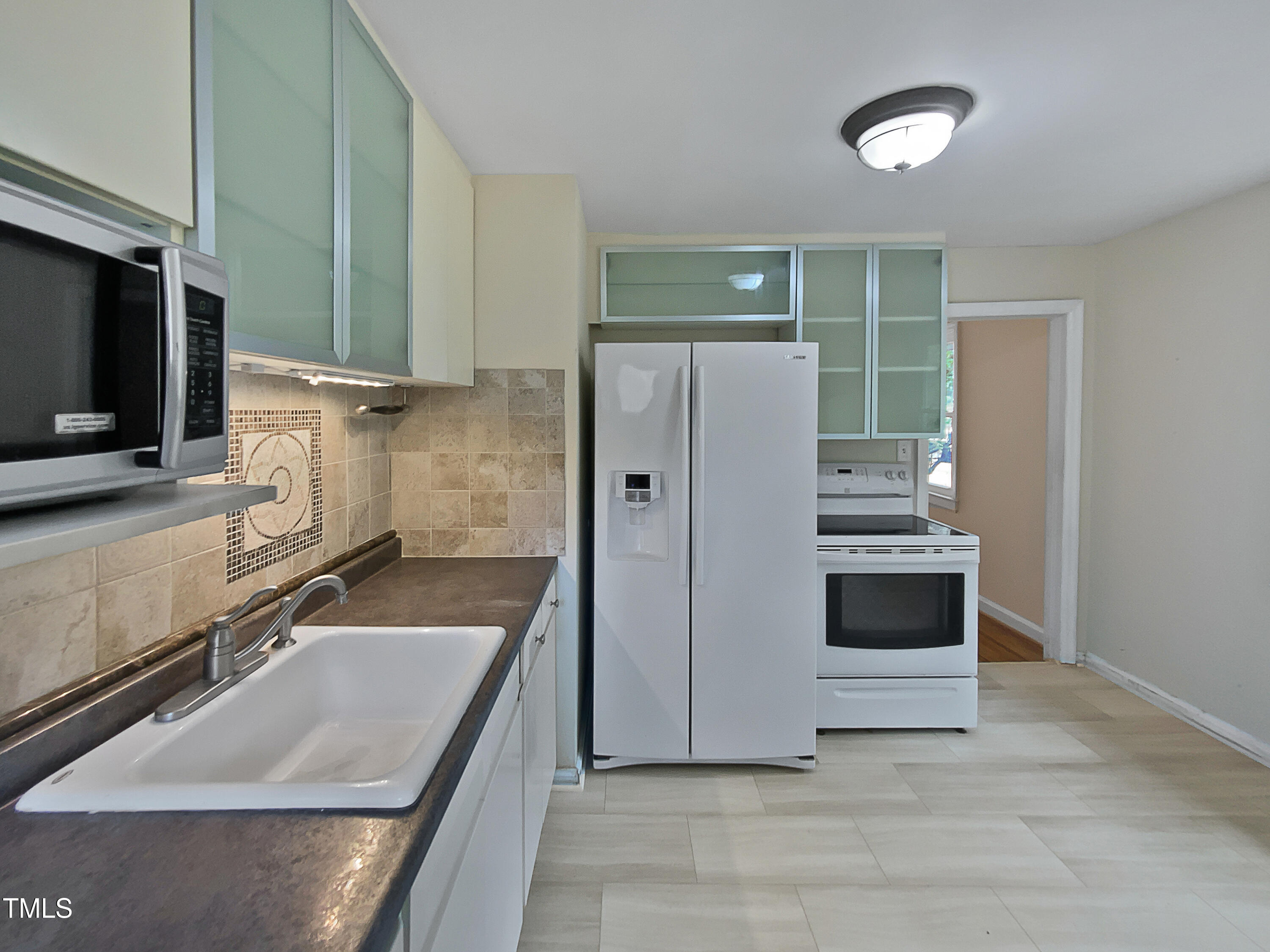 802 Powell Drive Garner, NC 27529 - Photo 6 of 17 a kitchen with a sink stove and refrigerator