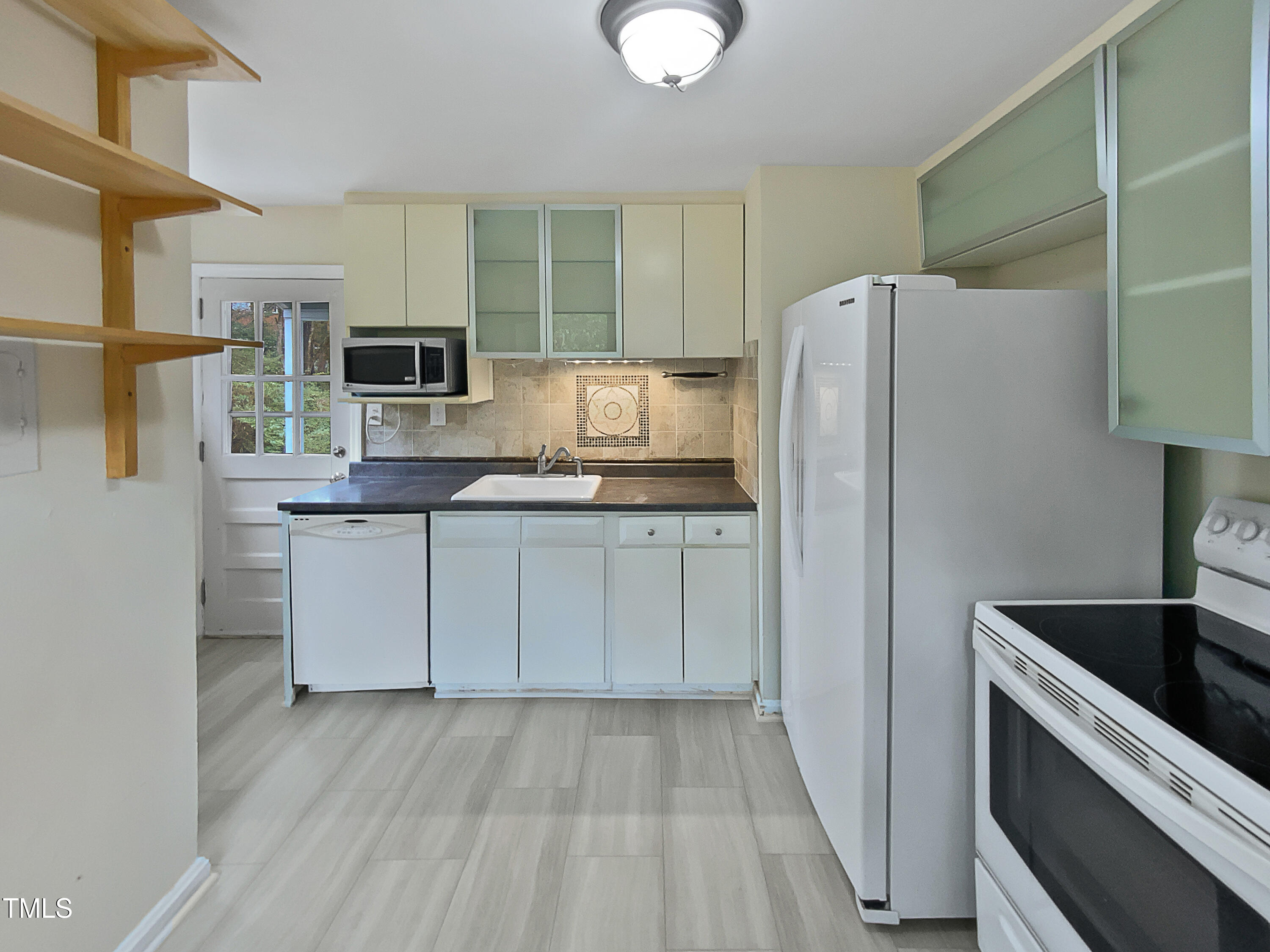 802 Powell Drive Garner, NC 27529 - Photo 9 of 17 a kitchen with stainless steel appliances a refrigerator sink and microwave