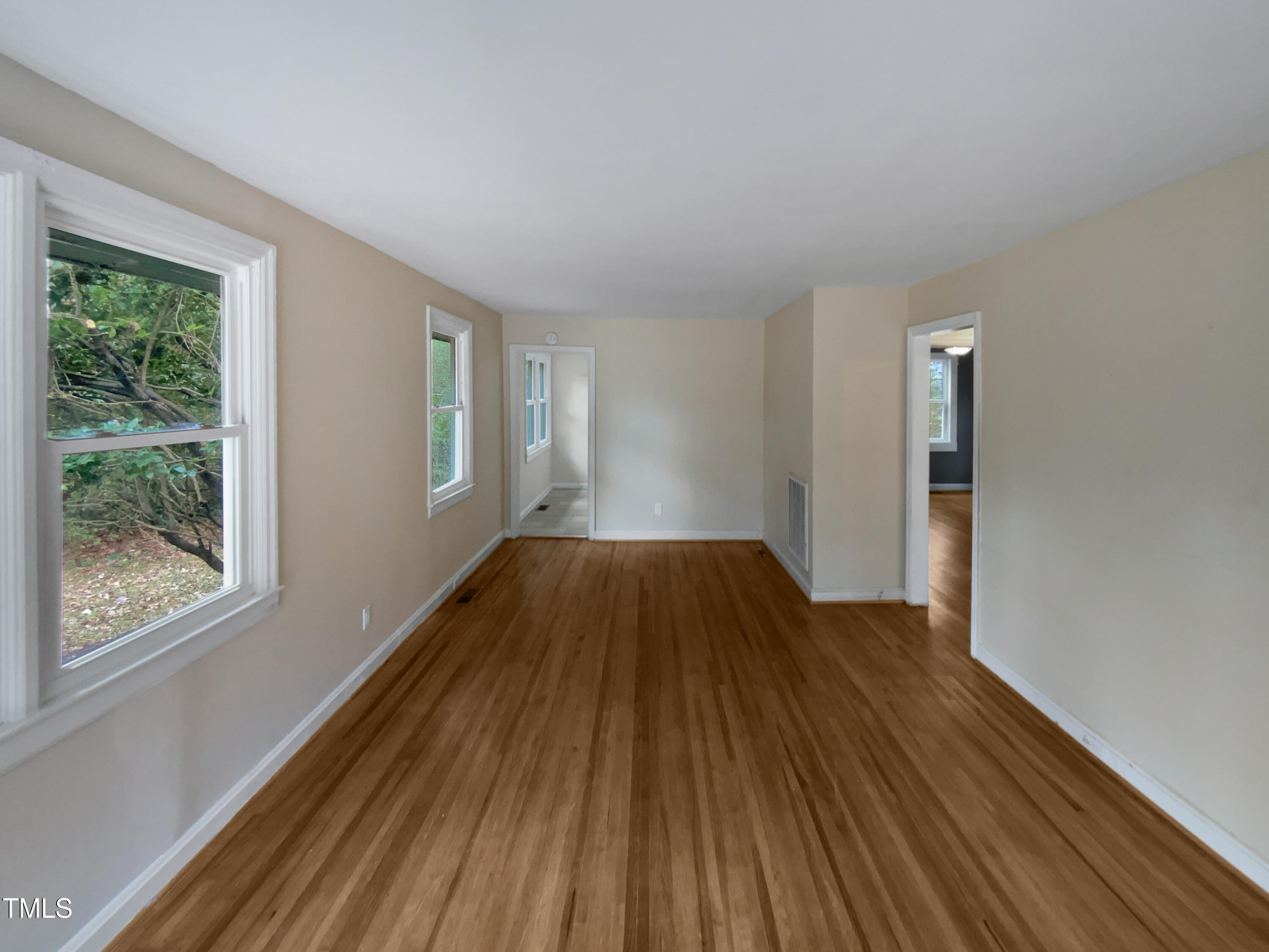 802 Powell Drive Garner, NC 27529 - Photo 10 of 17 wooden floor in an empty room with a window