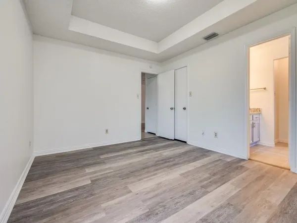 a view of an empty room and wooden floor