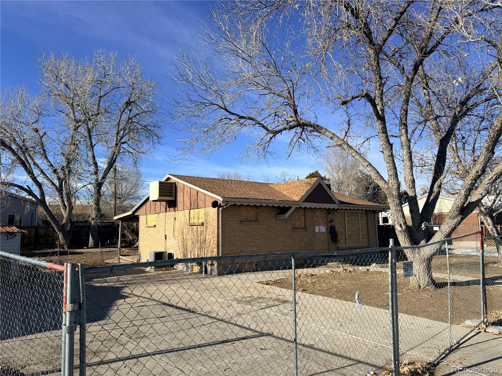 9111 Monroe Street Thornton, CO 80229 - Photo 5 of 39 a front view of a house with a yard