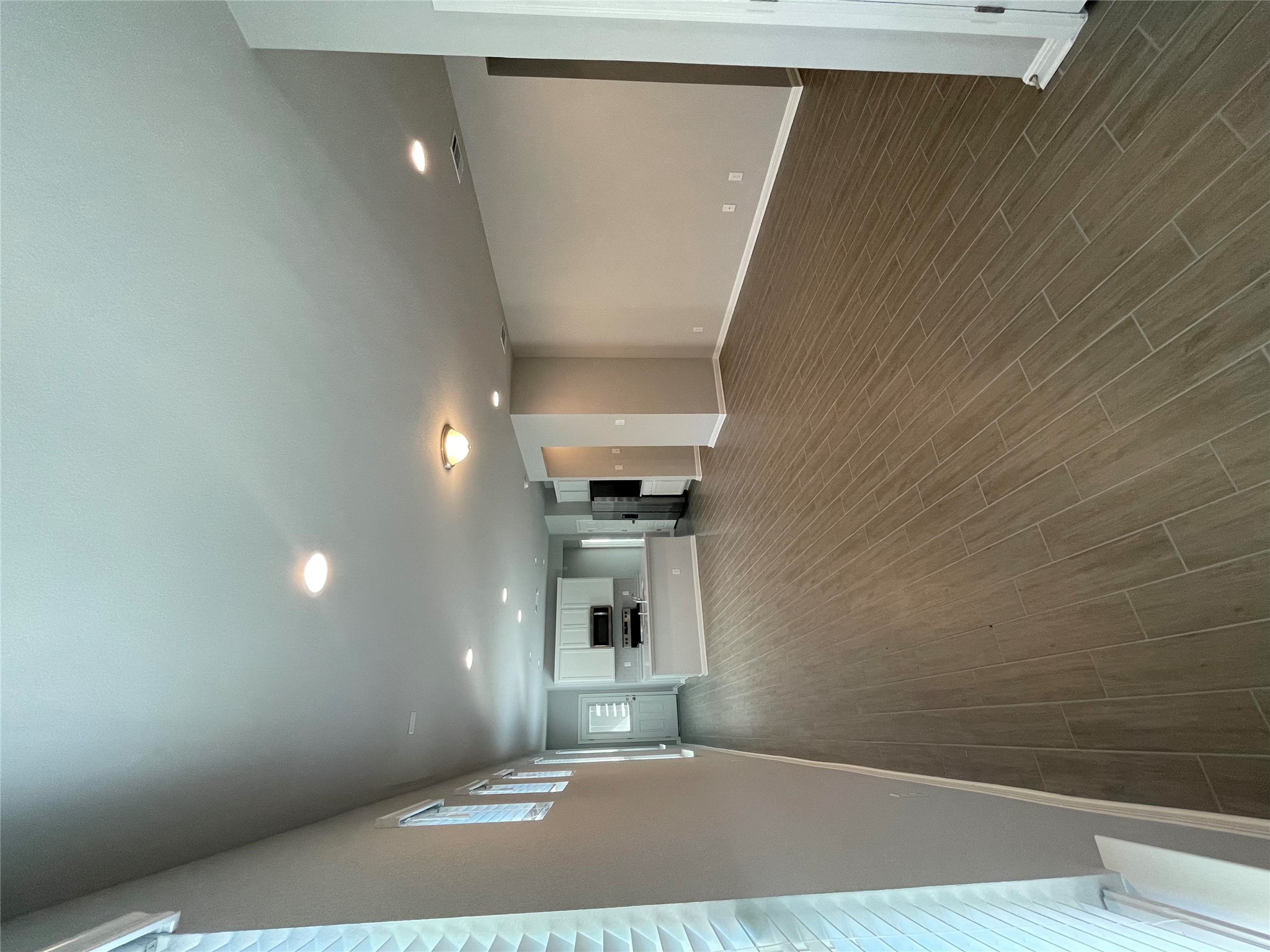 125 Unforgiven Lane Jarrell, TX 76537 - Photo 13 of 17 Unfurnished living room with wood finish floors and recessed lighting