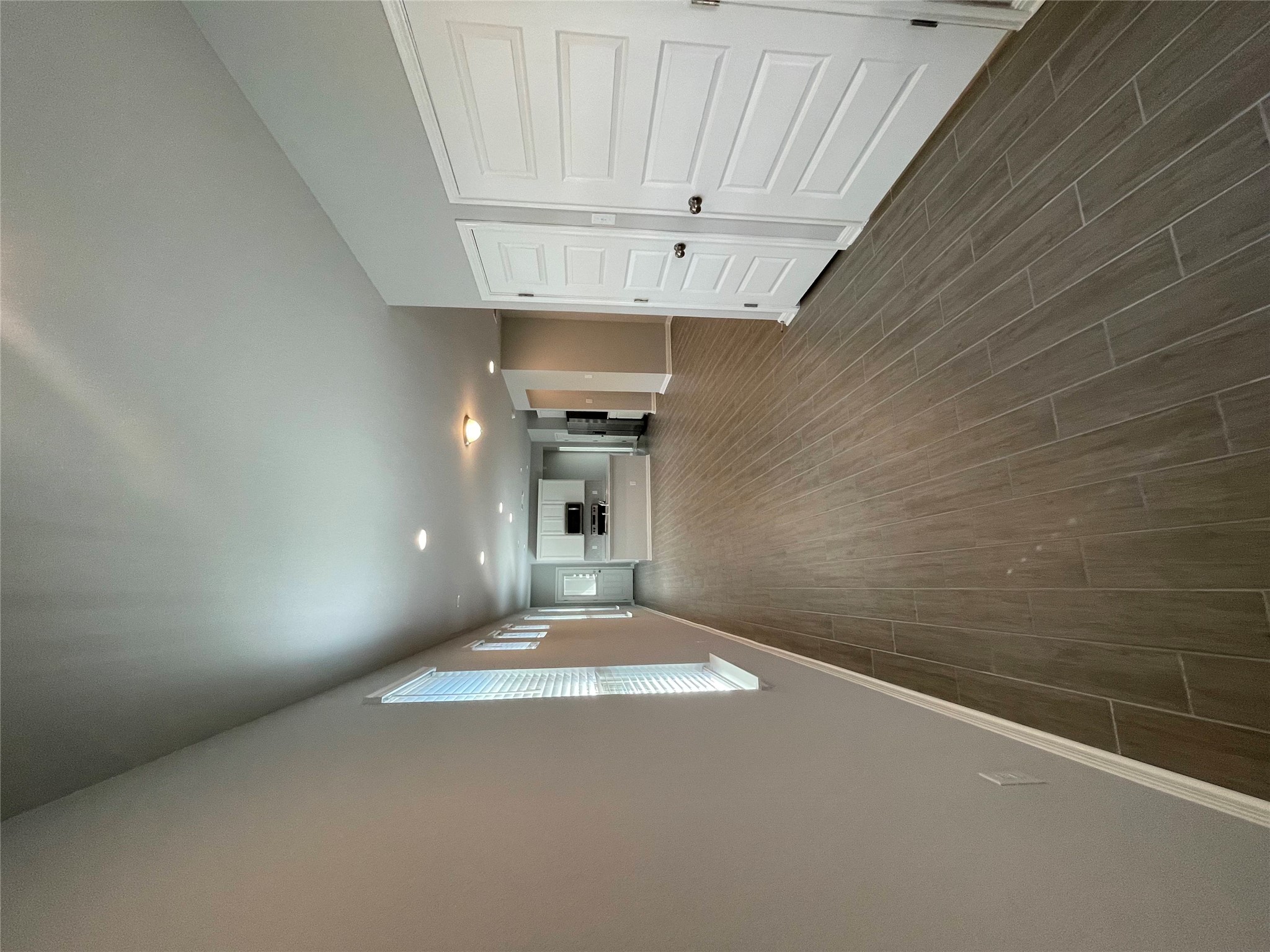 125 Unforgiven Lane Jarrell, TX 76537 - Photo 14 of 17 Unfurnished living room with baseboards and dark wood-style flooring